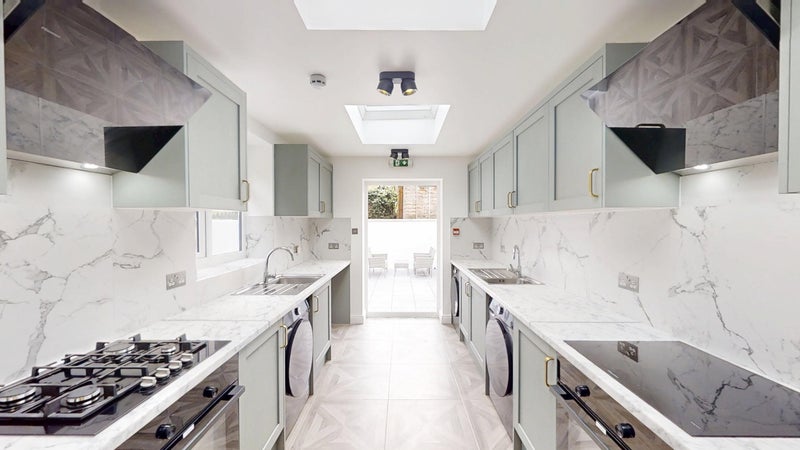 Photo 1: Dual kitchen setup, cooking with ease: Two fridges, two cookers and two sinks