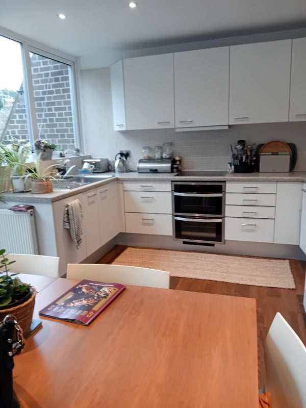 Photo 1: Modern, airy kitchen with access to peaceful balcony