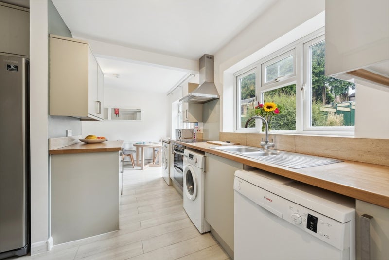 Photo 1: Open Plan Kitchen Lounge with Doors into Garden