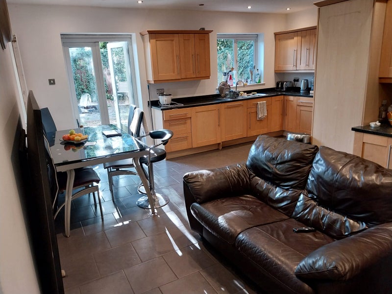 Photo 1: Main kitchen, dining area and communal tv area through to patio/garden