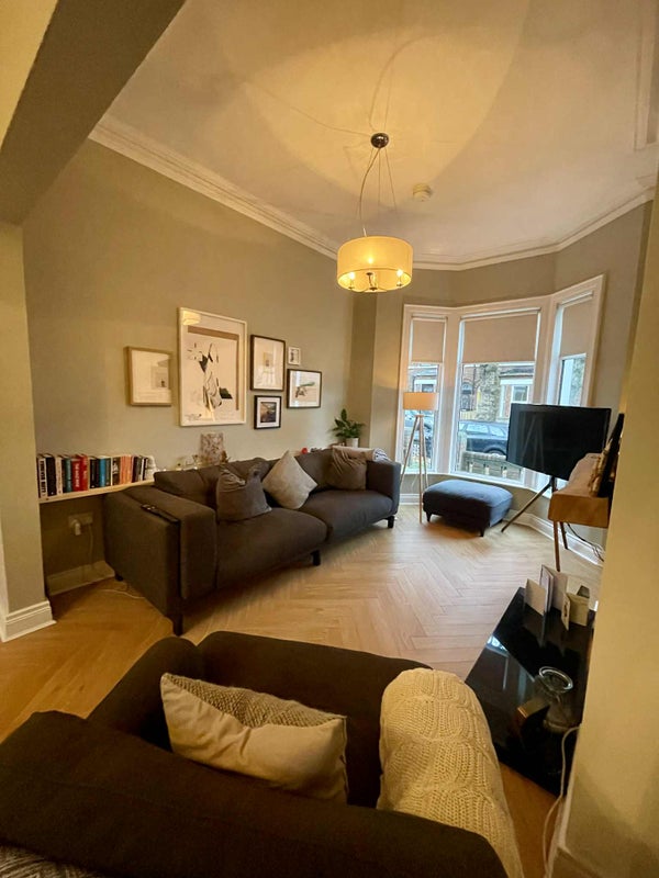 Photo 1: Open plan living and dining room with views of tree lined Deramore Avenue