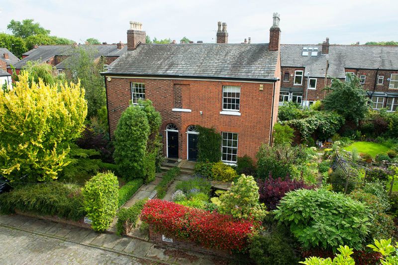 Photo 1: Front of house with private side garden