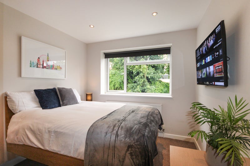 Photo 1: Bedroom + 43" Smart TV