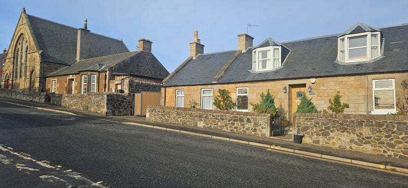 Photo 1: Front of cottage from main road