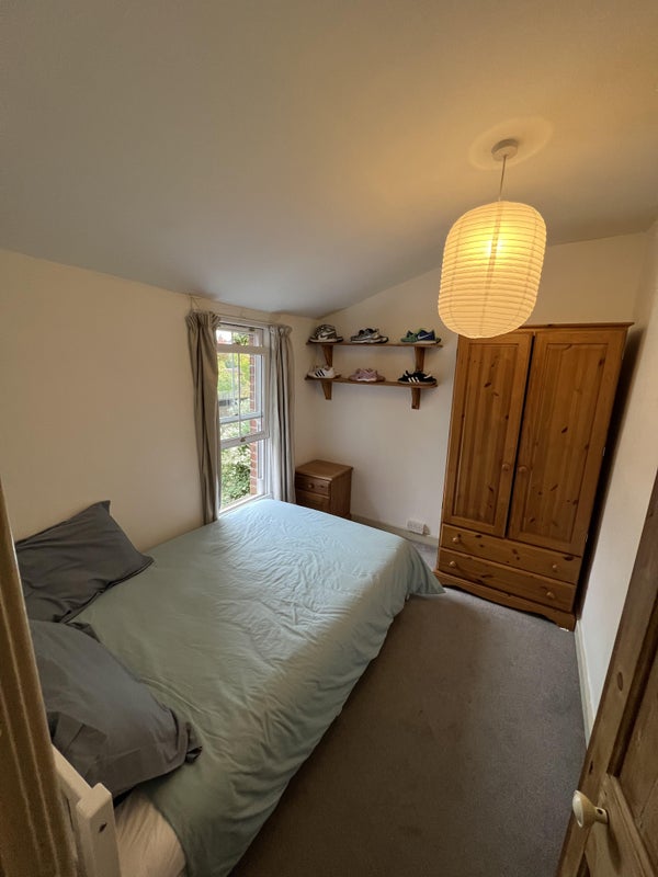 Photo 1: Bedroom comes with a closet, a single-double bed, a nightstand, curtains, and two shelves!