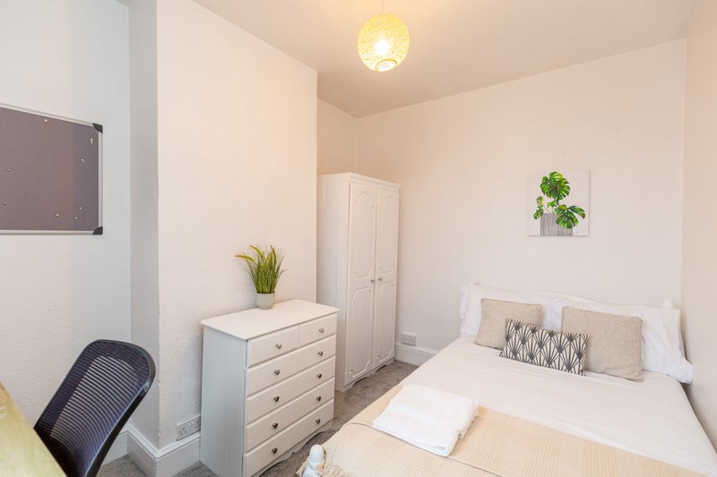 Photo 1: Room 4 is small with a double bed