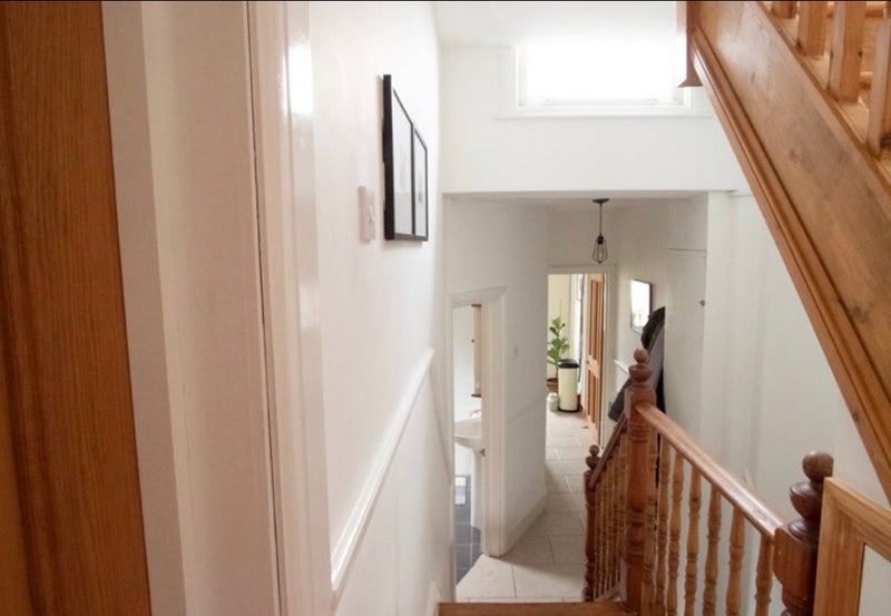 Photo 1: Hallway with bedroom door on left 
