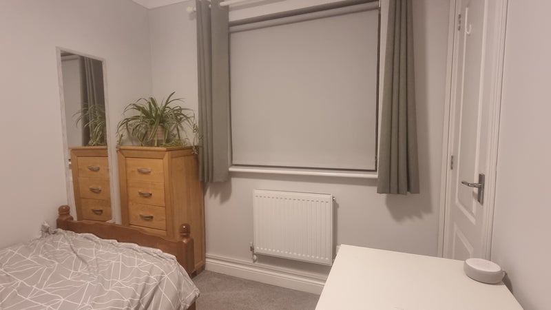 Photo 1: single bedroom with large cupboard behind the door pictured.