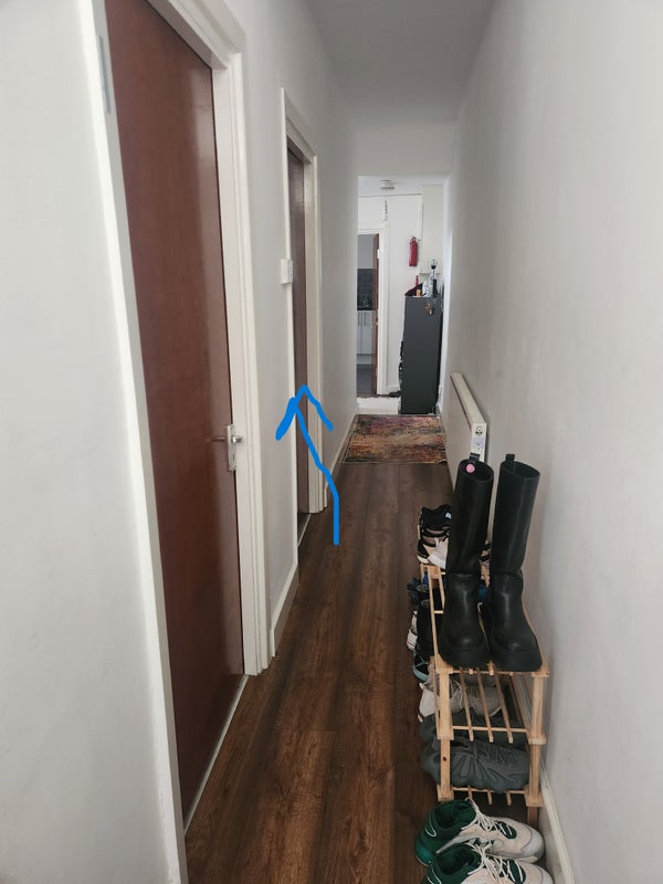 Photo 1: Entry hallway with arrow showing available bedroom  
