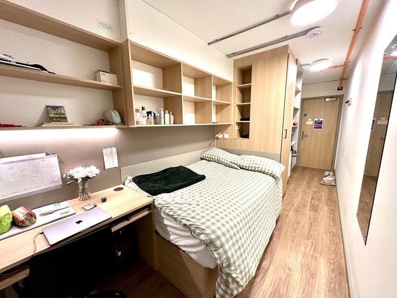 Photo 1: Room contains en suite bathroom, desk, desk chair, bookshelf, mirror, wardrobe, storage space and a 