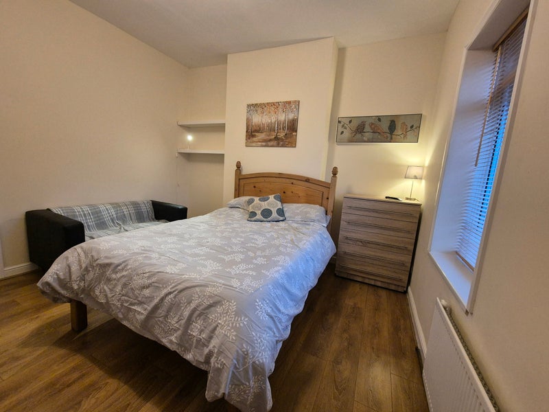 Photo 1: Double bed and sofa in room