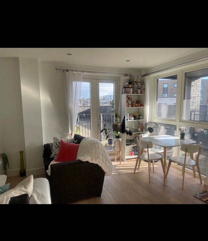 Photo 1: Shared living room with view of balcony