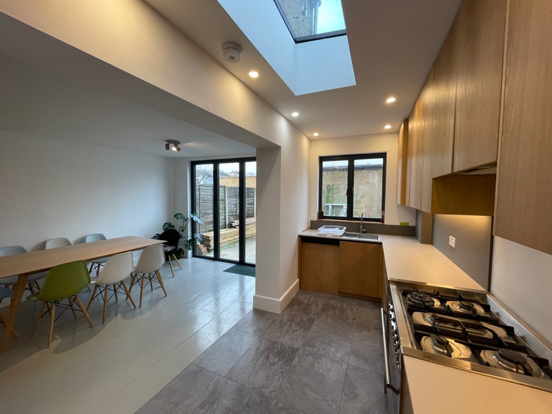 Photo 1: Shared Kitchen and Living Area (patio access)