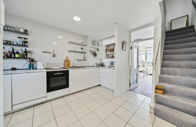 Photo 1: Kitchen and stairway