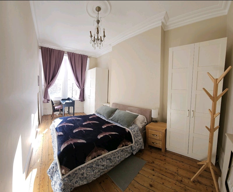 Photo 1: Room with 2 large wardrobes and a desk near the window.