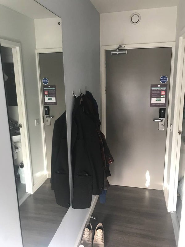 Photo 1: Mirror and wall hooks by the entrance