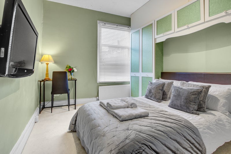 Photo 1: Bedroom with TV, desk & chair