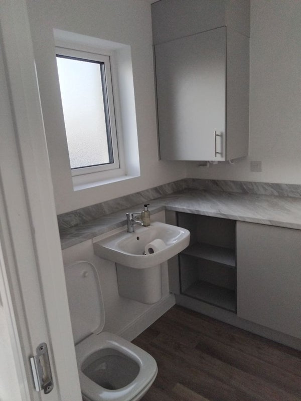 Photo 1: Downstairs toilet & Laundry 