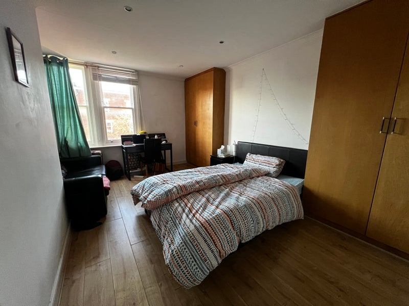 Photo 1: Bedroom with desk and couch