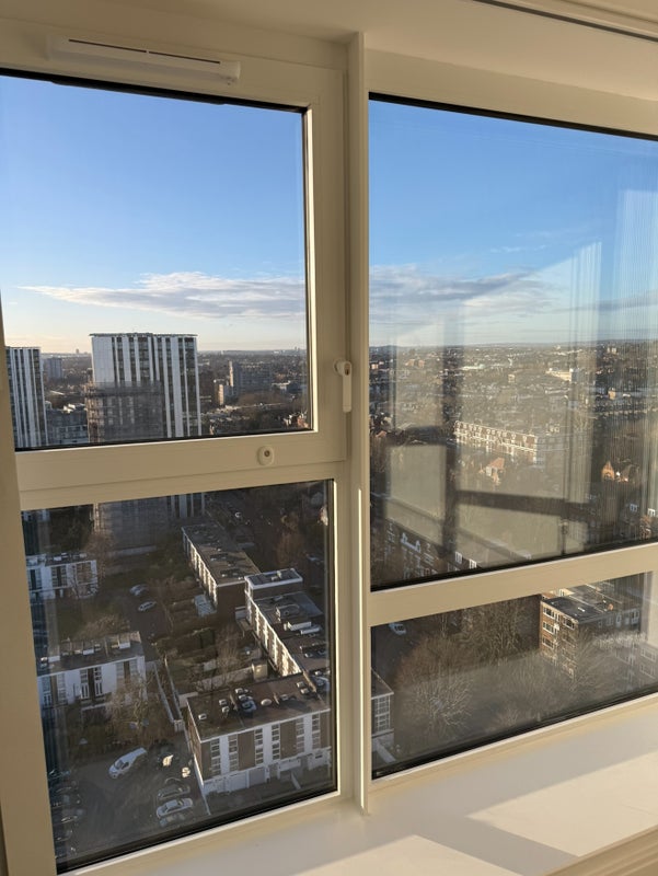 Photo 1: Skyline view from Living room