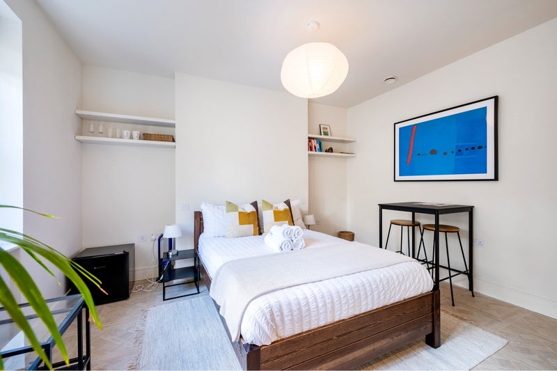 Photo 1: Bedroom. Note there is a desk there now instead of a high table.