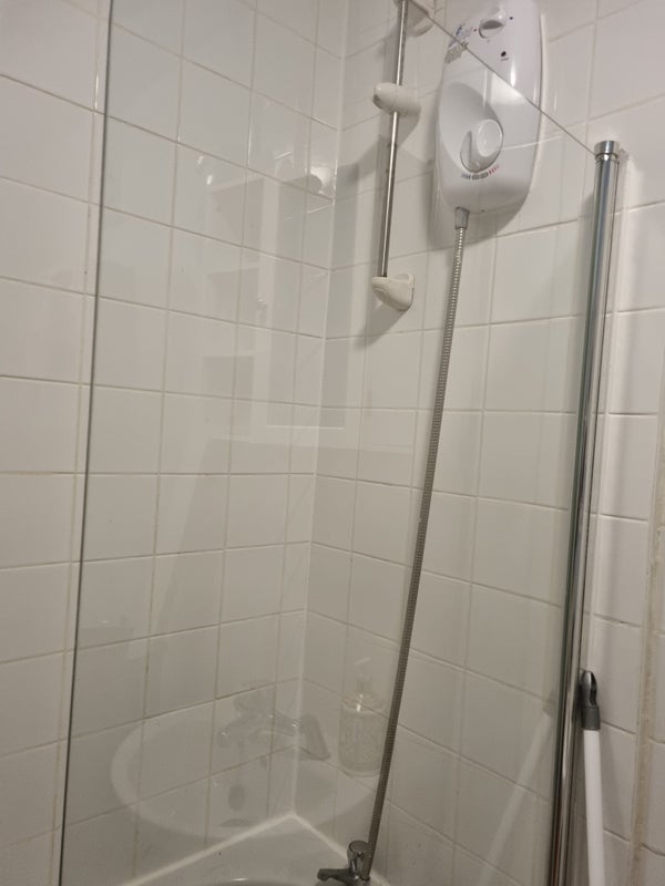 Photo 1: Bath tube with a shower