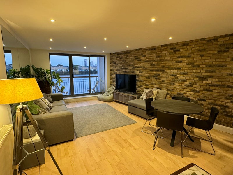 Photo 1: Living room and balcony with views to the River 