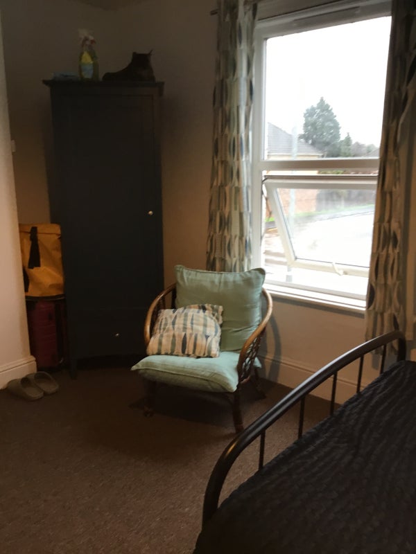 Photo 1: Comfy chair  by one of two large windows, with wardrobe
