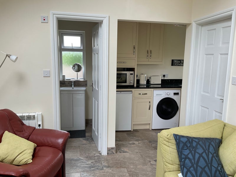 Photo 1: Kitchen area and shower room