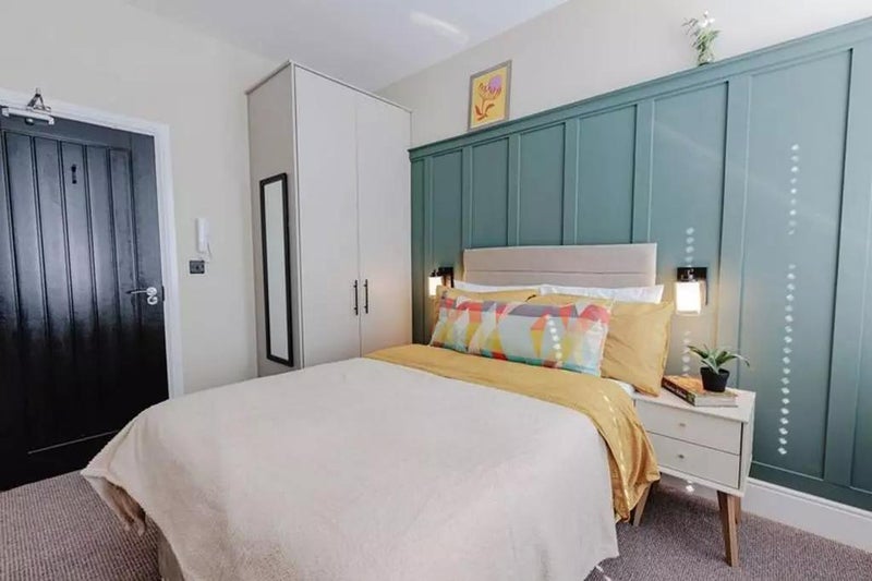 Photo 1: Double bed room with a wardrobe, bed side table, mirror and close to radiator for warm cozy bed rest