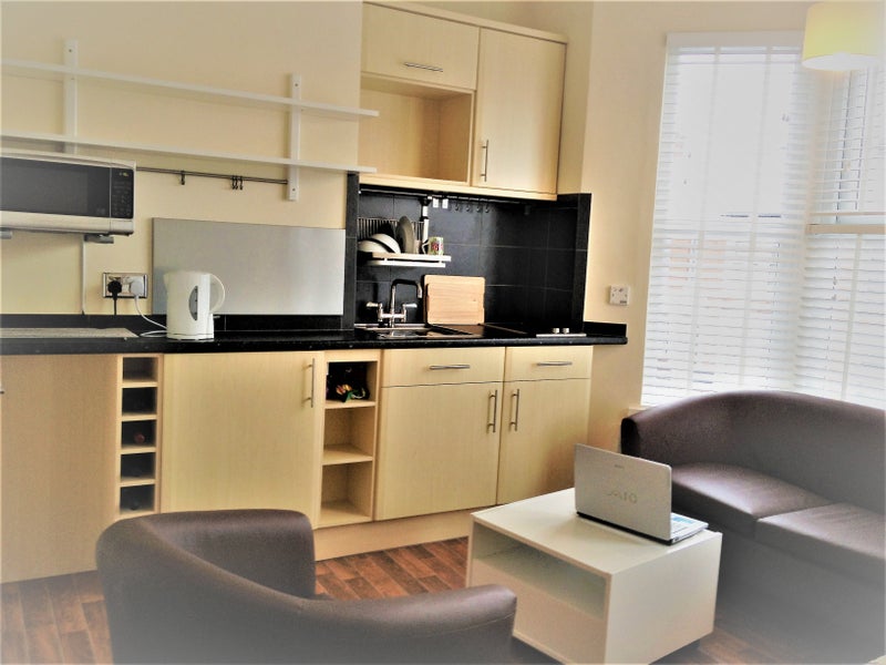 Photo 1: Studio Room showing coach and chair