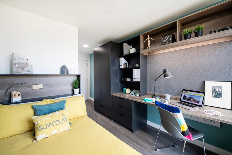 Photo 1: Furnished modern en-suite bedroom with built-in desk and storage