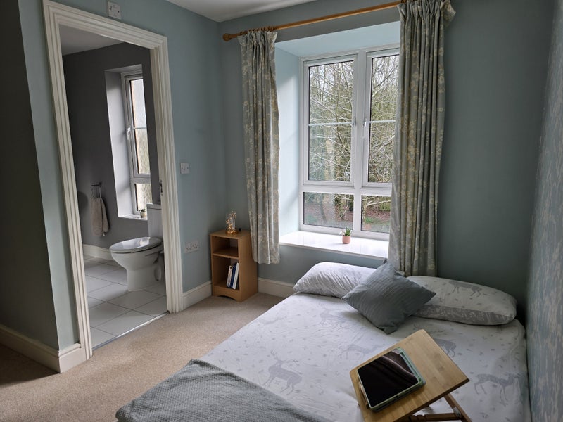 Photo 1: Comfortable double bed with fresh, neutral bedding.