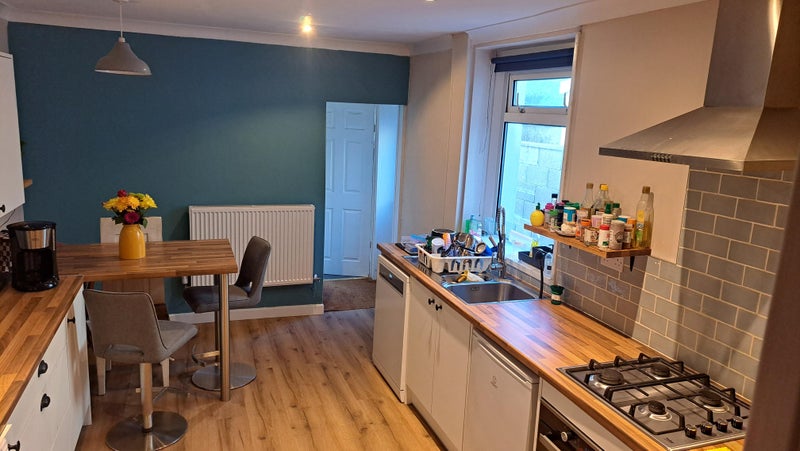 Photo 1: Kitchen leading to bathroom & garden 