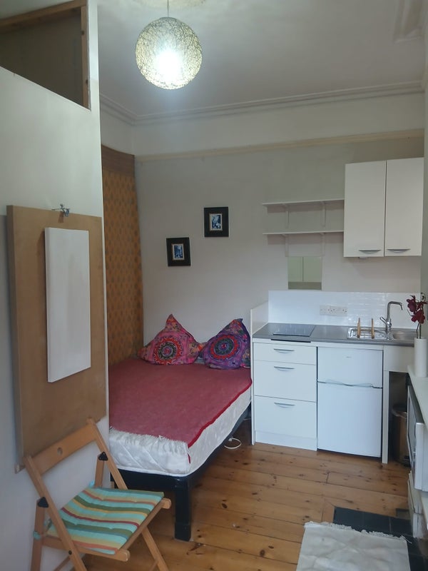 Photo 1: bed and main area