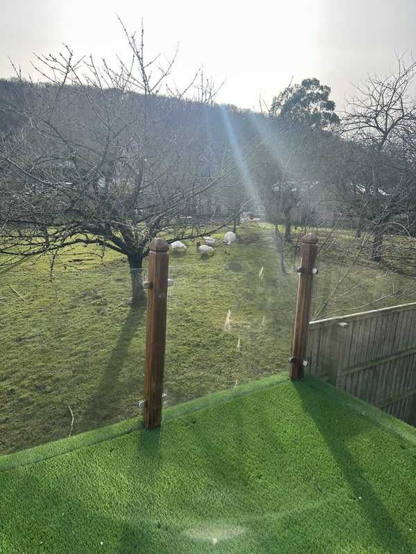 Photo 1: Glass balcony looking over orchard 