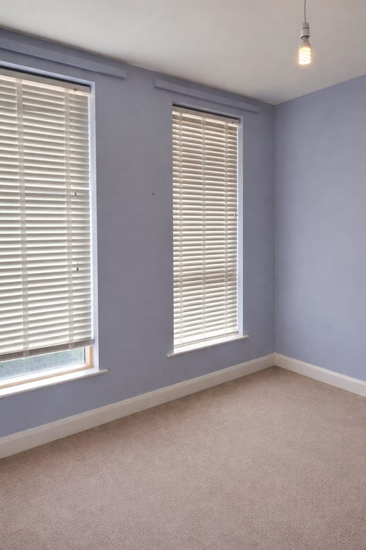 Photo 1: One end of the bedroom which could fit a lounge area if desired