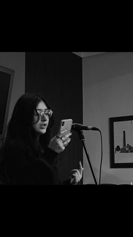 Photo 1: Me, doing some spoken word at an open mic!