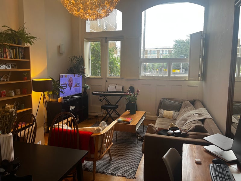 Photo 1: Living room with sofa, TV, dining table