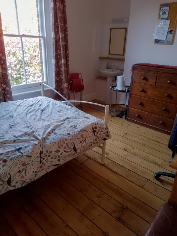 Photo 1: view of double bed, basin  and window 