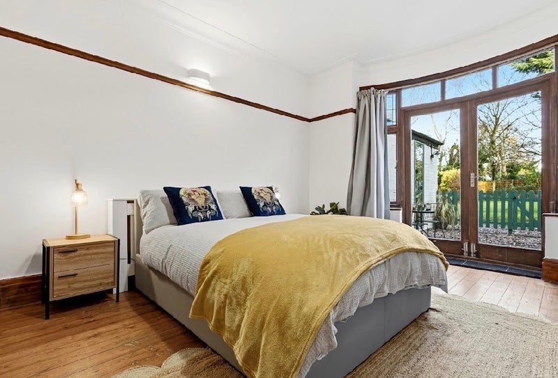 Photo 1: Spacious room with original wooden floors, WFH area, garden access and room to actually chill