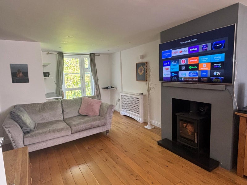 Photo 1: Living Room. Smart TV, Fireplace and Sofa