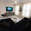 Photo 2: Bright and spacious living area with plenty of natural light, perfect for relaxing or socialising.