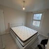 Photo 3: Spacious double room with built-in storage and wardrobe space.