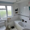 Photo 3: Private bathroom with bath/shower combo, toilet, and sink.