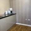 Photo 3: The guest has shared access to the middle-floor room which doubles as a kitchenette / utility (a tab