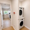Photo 11: Hallway with 2 washer dryers 