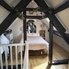 Photo 3: The south end of the room, currently used as a sleeping area.