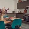 Photo 2: Shared kitchen with long dining table