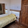 Photo 3: Single bed and shelves in room